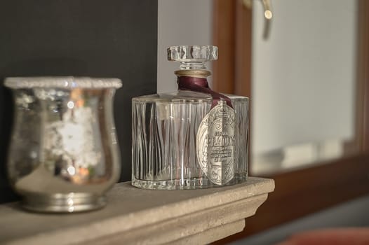 Glass bottle of empty liquor used as a decorative element in a luxury home.