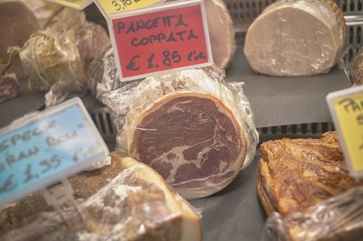 Italian Kitchen: sausages for sale in the refrigerator of a supermarket counter.