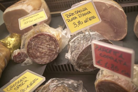 Many meat sausages on sale at the market: an expression of Italian cuisine.