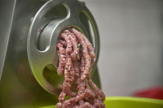 Detail of minced meat while leaving the grinder