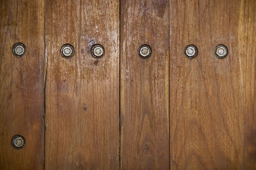 Texture of dark wood planks with exposed screws.