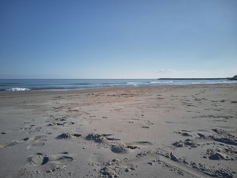 View of a deserted beach with impronet on the sand left by the passage of someone who has ventured to visit this place of peace and tranquility.