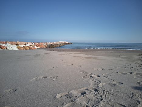 Landscape including the sea, the beach and a cliff on the left: A peaceful and quiet place.