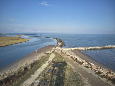 Aerial view of the beach of Rosolina Mare in Veneto (Italy) taken from a drone where you can see the beach and the sea get lost in the horizon.