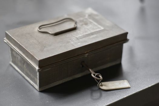 Old locked safe with the key inserted.