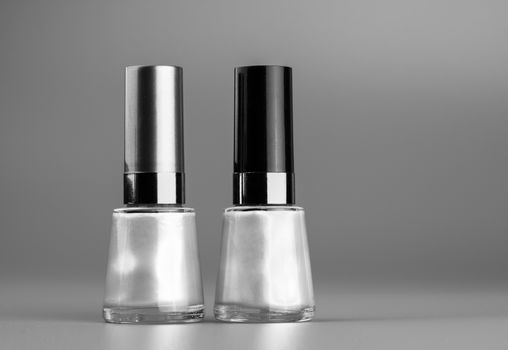 Black and white image of two nail polish bottles