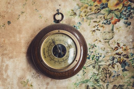 Dusty vintage barometer in old house, the writing is in french