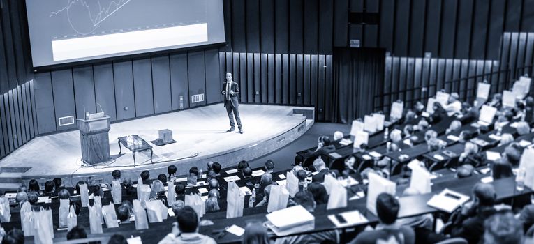 Speaker Giving a Talk at Business Meeting. Audience in the conference hall. Business and Entrepreneurship concept.