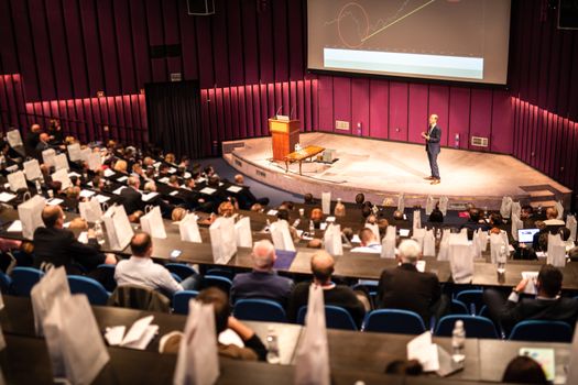 Speaker Giving a Talk at Business Meeting. Audience in the conference hall. Business and Entrepreneurship concept.