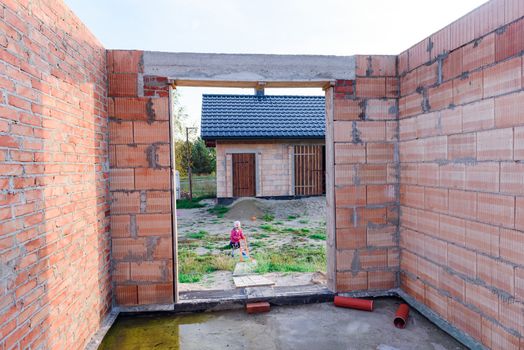 Interior of a Unfinished Red Brick House Walls under Construction without Roofing.