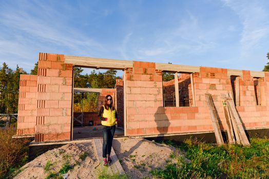 Exterior of a Unfinished Red Brick House Walls under Construction without Roofing.