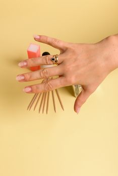 The procedure for removing varnish from nails hybrid nails in progress. Gel nail polish remover foils on woman's hands