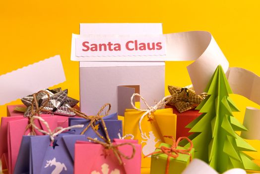 Long twisted expanded letter for Santa Claus. Copy space. yellow background. Santa Claus paper home at north pole.