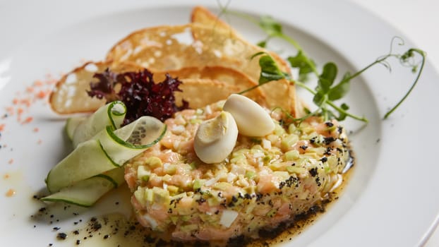 The salmon tartare with avocado. Shallow dof.