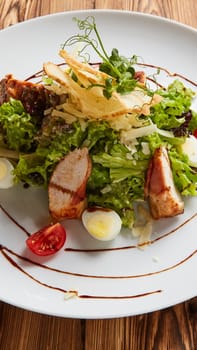 Chicken Salad. Chicken Caesar Salad. Caesar Salad with grilled chicken on plate. Grilled chicken breasts and fresh salad in plate