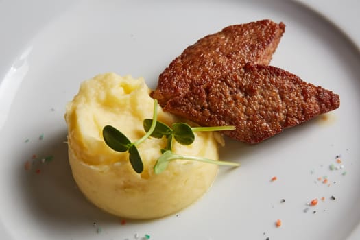 delicious mashed potatoes sprinkled with greens, juicy meat cutlets.