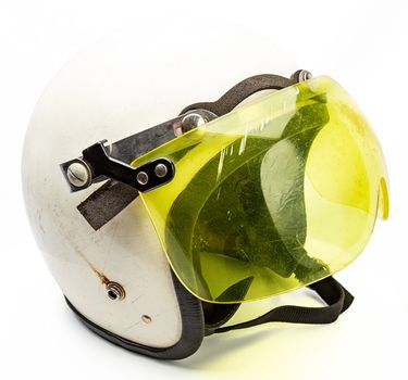 Old white snowmobile helmet with yellow visor