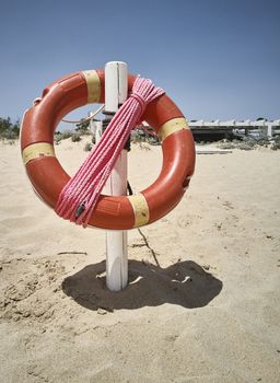 Lifebuoy hanging on the beach ready to use in case of need: safety device.