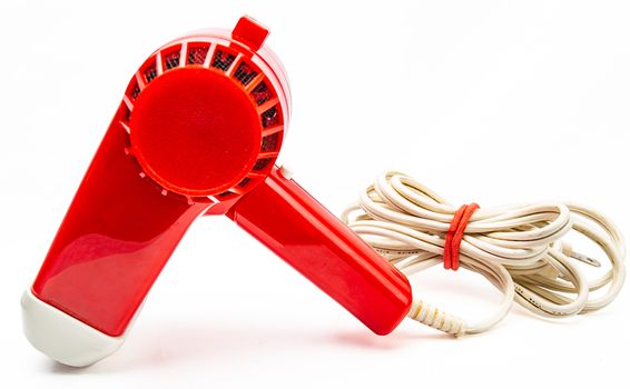 Vintage red plastic hair dryer isolated on white background