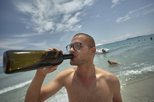 Young alcoholic boy drink from a bottle