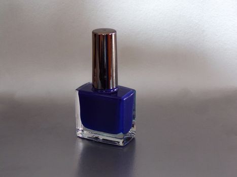Nail Polish isolated on white background. Blue female nail Polish.