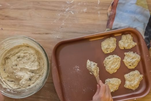 Preparation of homemade date and nut crackers. Wooden table and glass bowl