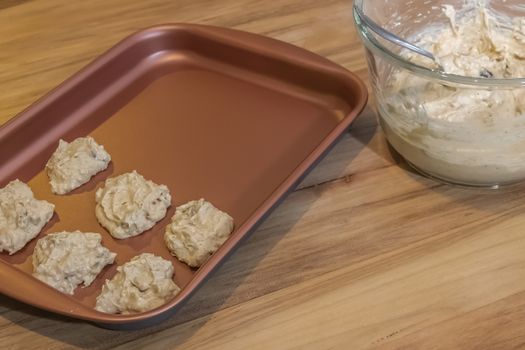 Preparation of homemade date and nut crackers. Wooden table and glass bowl