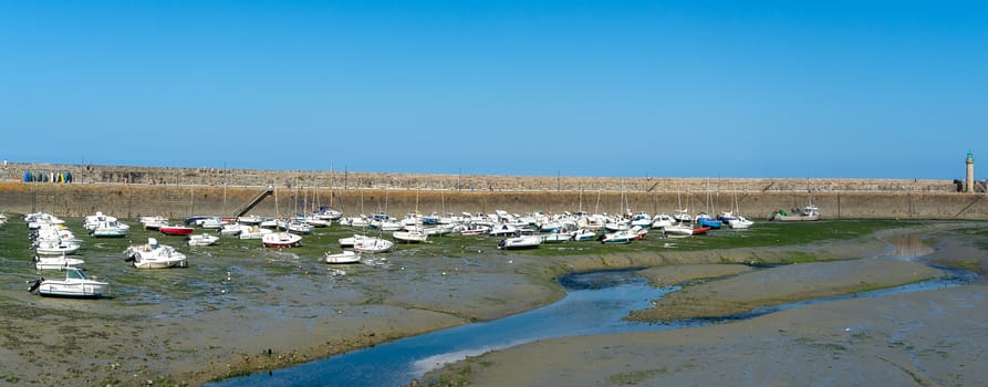 Sea and yachts during tide on sea shore of France in summer