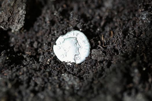 Silver denarius in the ground