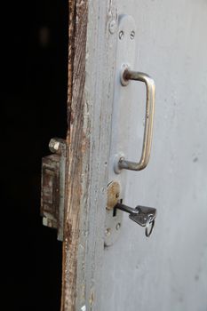 gray door with key and door handle