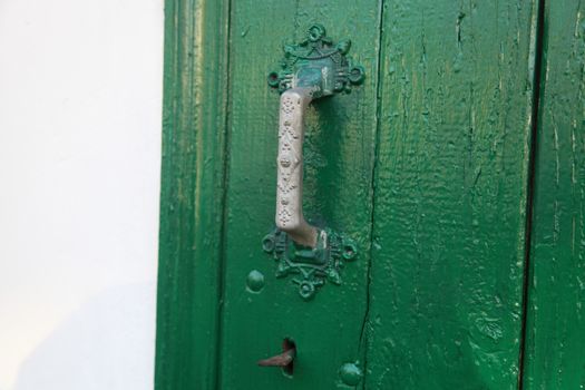 Green door with key and door handle