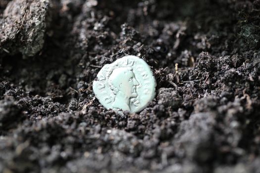 Silver denarius in the ground
