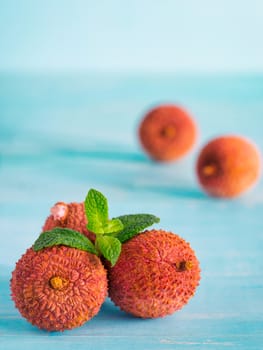 lichee fruit on turquoise wooden background close up