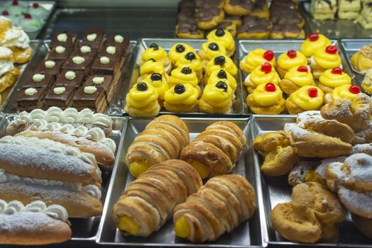 Italian pastry shop. Showcase on pastry shop. Cream and sweets.