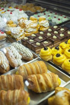 Italian pastry shop. Showcase on pastry shop. Cream and sweets.