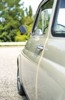 Vintage beige color car. Small old car. Italian car. Sunny day