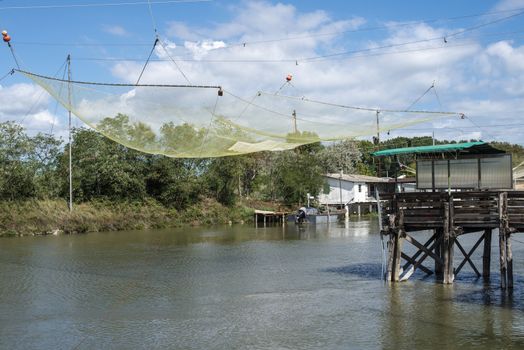 Fishing houses in dock and fishnet. Empty fishnets.