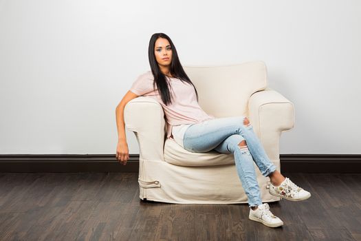 young woman relaxing on a one seat couch