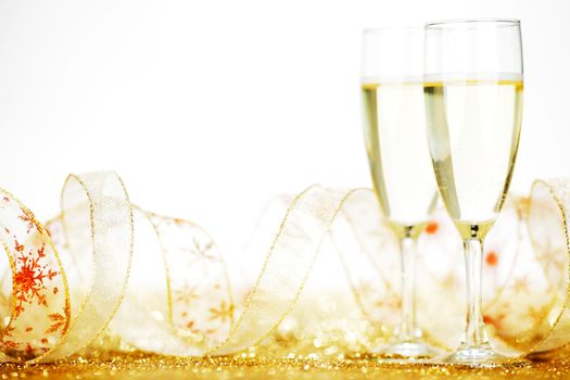 Two glasses of champagne with bow on golden background