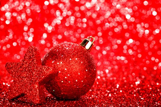 Beautiful red christmas balls on abstract glitter background close-up