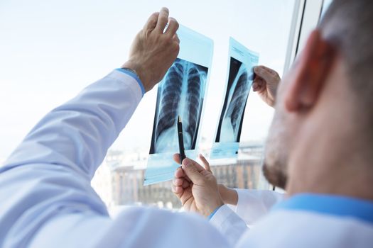 Healthcare, medical: Group of doctors discuss and looking x-ray in a clinic or hospital