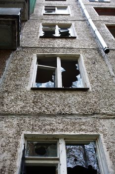 Eviction concept. Old abandoned building with shattered windows