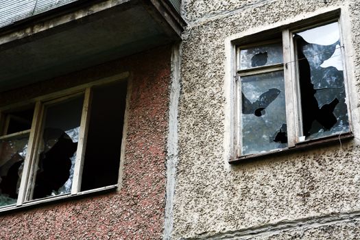 Eviction concept. Old abandoned building with shattered windows