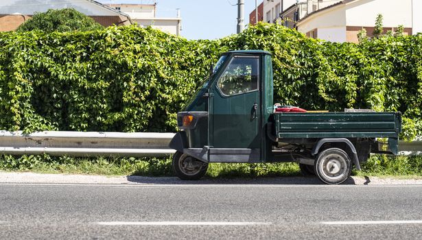 Typical italian agriculture small truck on three wheels. Ape transport in Italy.