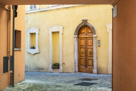 Typical italian facade with door.  Italian house. Traditional style and ornaments. 