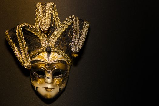 masks and feathers of venice carnival on black background