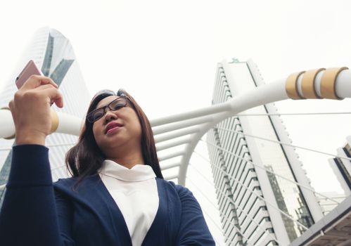 businesswoman walking outdoor and talking on mobile phone