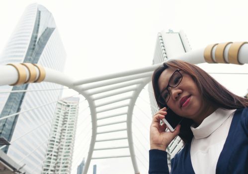 businesswoman walking outdoor and talking on mobile phone