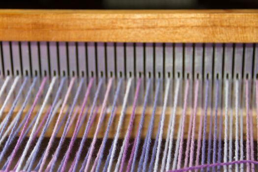 detail of fabric in comb loom with ultraviolet and lilac colors