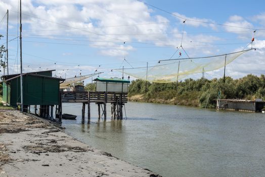 Fishing houses in dock and fishnet. Empty fishnets.